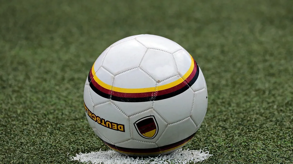 Two players chasing the ball in a football match